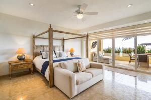 a bedroom with a bed and a couch and a bed and window at Luxury Oceanfront Condo Infinity Pool in Punta Mita