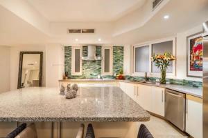 a kitchen with a large island with a counter top at Luxury Oceanfront Condo Infinity Pool in Punta Mita