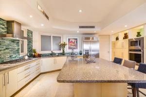 a large kitchen with a large island in the middle at Luxury Oceanfront Condo Infinity Pool in Punta Mita +42 photos