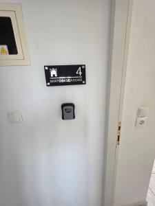 a sign on the side of a room with a door at Mirtos4seasons Harmony in Myrtos
