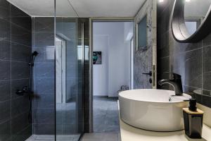 a bathroom with a tub and a glass shower at Mirtos4seasons Harmony in Myrtos +64 photos