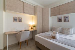 a small bedroom with a bed and a desk at 4 minutos da Praia de Copacabana - NSC803 in Rio de Janeiro