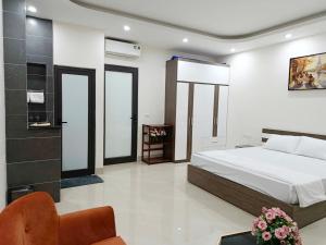 a bedroom with a bed and a chair in a room at Ha Noi Smile Home in Ðình Loan +17 photos