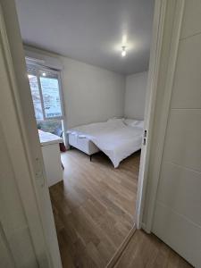 a small bedroom with a bed and a window at Opposite Metro 14 - Guest Room - Paris & Orly in Chevilly-Larue +6 photos