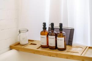 four bottles of wine sitting on a cutting board at Jungle House Columbus Sleep 16 Downtown Ohio Free Parking - Near Convention Center & Nationwide Arena - 4BR Luxury Home - Pet Friendly - Over 5,800 Five Stars in Columbus +118 photos