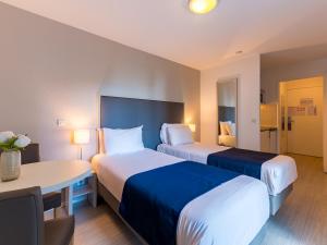 Postel nebo postele na pokoji v ubytování Séjours & Affaires Pantin Charles De Gaulle