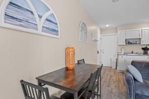 a dining room and kitchen with a table and chairs at Torch Lake Vista A-Ga-Ming Golf Retreat 741 in Creswell