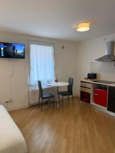 a room with a table and chairs and a kitchen at Appartamenti Anna in Sirmione +20 photos