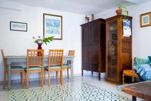 a dining room with a table and chairs at Vilamurada • Terraza con vistas al casco antiguo in Denia