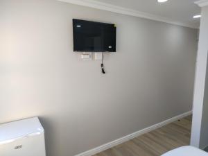 a room with a tv on the wall at Cosmic View Lodge in East London