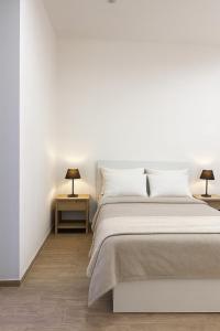 Postel nebo postele na pokoji v ubytování Cìvitas Suite ApartHotel