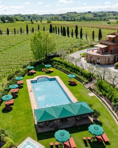 an overhead view of a swimming pool in a field with umbrellas at Poggio al Casone in Crespina +30 photos