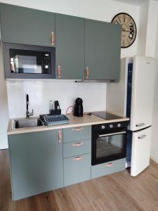 a small kitchen with a sink and a microwave at T2 d'Anne proche plage et marché in La Baule