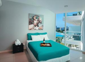 a bedroom with a blue bed and a large window at Luz de Laguna in Playa Blanca +50 photos