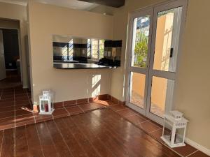 an empty room with a kitchen with a window at Outspan Lodge in Fish hoek