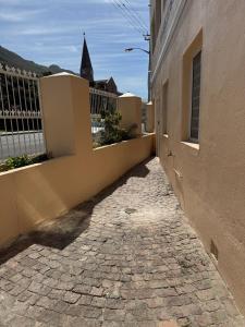 a cobblestone alley in front of a building at Outspan Lodge in Fish hoek