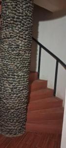 a stone wall next to a staircase with wooden steps at Lalibela Circle Guest House in Lalibela