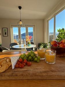 a table with fruits and vegetables on a cutting board at Botanisk Spa-retreat - Badstue & Foss - Magisk sted in Vossevangen +33 photos