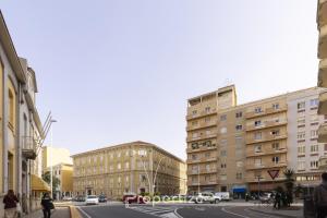 a city street with buildings and cars on the road at Central Cagliari by Propertize in Cagliari