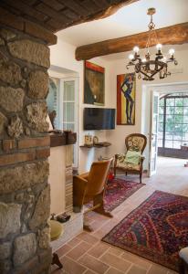 a living room with a stone wall at Don Carlo Agriturismo di Charme Bio in Le Pioppe