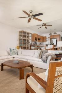 a living room with a white couch and a table at Luxury Oceanview Condo Steps to El Anclote in Punta Mita