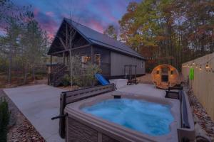 a hot tub in a yard next to a building at The Elk Camp in Benezette