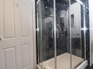 a shower with a glass door in a bathroom at Baywood Cottage in Keighley +22 photos