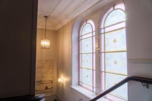 a large window in a building with a staircase at The Harrogate Inn - The Inn Collection Group in Harrogate