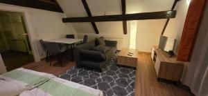 a living room with a couch and a table at Ferienwohnung "Dachblick" Bad Elster in Bad Elster