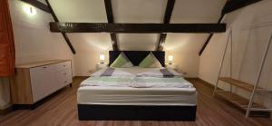 a bedroom with a bed with a wooden floor at Ferienwohnung "Dachblick" Bad Elster in Bad Elster