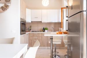 a kitchen with white cabinets and a white counter top at Lime Calabria Apartment in Falerna Marina