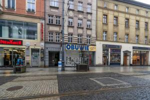 an empty street in a city with buildings at Katowice Central Apartment by BookingHost in Katowice