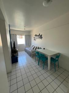 a living room with a table and chairs and a bed at Ametista 2 Beira Mar in Maceió