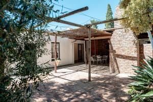 a patio of a house with a brick wall at Cottage at 48 in Graaff-Reinet