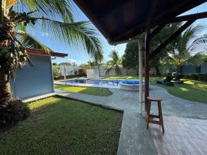 a patio with a chair next to a swimming pool at Yubarta Lodge in Uvita