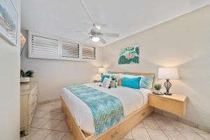 a bedroom with a bed and a ceiling fan at Kihei Surfside 306 · KSS 306 Updated BeachFront 1BD w Ocean View in Wailea