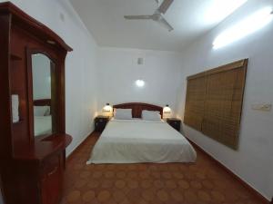 Postel nebo postele na pokoji v ubytování Rainbow Homestay Wayanad