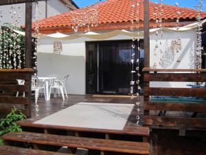 a patio with a table and chairs on a deck at Vila Poloneza 2 Mai in 2 Mai