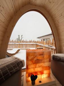 a room with an arched window and a table with a box at Agritur Maso Librar in Trento