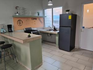 a kitchen with a refrigerator and a sink and a counter at Sagitario dpto in Tuxtla Gutiérrez