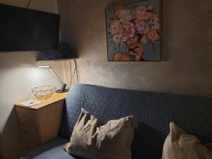 a bedroom with a bed with a night stand and a television at APARTMANI Emerald Dream in Novi Sad