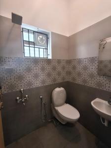 a bathroom with a toilet and a sink at The Loft OMR in Chennai +36 photos