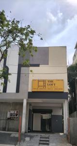 a building with a yellow sign on top of it at The Loft OMR in Chennai