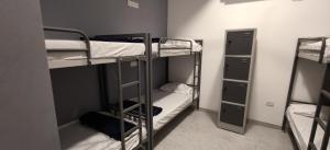a room with three bunk beds in a room at The Loft OMR in Chennai
