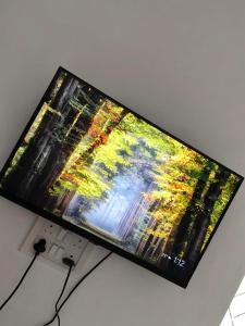 a flat screen tv sitting on top of a table at The Loft OMR in Chennai