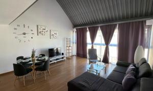 a living room with a couch and a table at La Morada in Alcalá de Henares