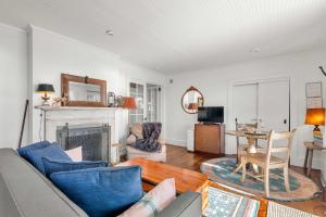 a living room with a couch and a fireplace at Waterfront with Private Beach Stunning Views in Provincetown +21 photos