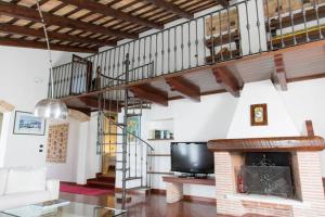 a living room with a fireplace and a staircase at Villa Vittoria in Citta' Sant'Angelo