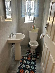a bathroom with a toilet and a sink at Hatfield - Staylax Manor 3 in Harare