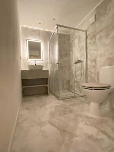 a bathroom with a shower and a toilet and a sink at Wellness Minikvítek in Smržovka +4 photos